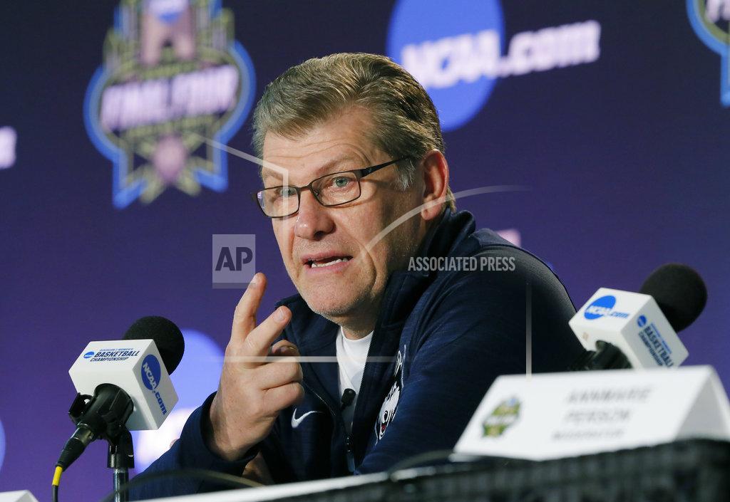 Tony Gutierrez File-This March 30, 2018, file photo shows Connecticut head coach Geno Auriemma talking to the media during a news conference at the women's NCAA Final Four college basketball tournament in Dallas. College basketball season's starting earlier and earlier and that's something top coaches Muffet McGraw and Auriemma aren't thrilled about it. A sport that used to begin practice around Oct. 15 and have its first games at Thanksgiving is now beginning nearly three weeks sooner. Tuesday, Nov. 6, 2018, will be the first day of games with nearly 100 women's contests scheduled and nearly 150 men's ones as well.(AP Photo/Tony Gutierrez, File)