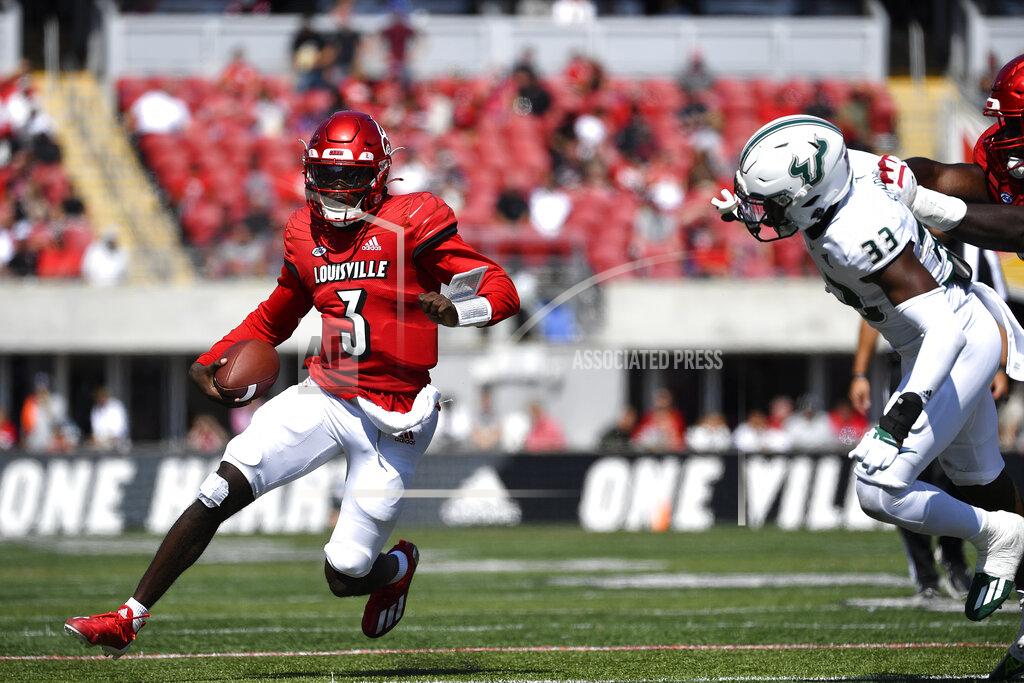 Timothy D. Easley Louisville quarterback Malik Cunningham (3) is pursued by South Florida cornerback Timarcus Simpson (33) during the second half of an NCAA college football game in Louisville, Ky., Saturday, Sept. 24, 2022. Louisville won 41-3. (AP Photo/Timothy D. Easley)