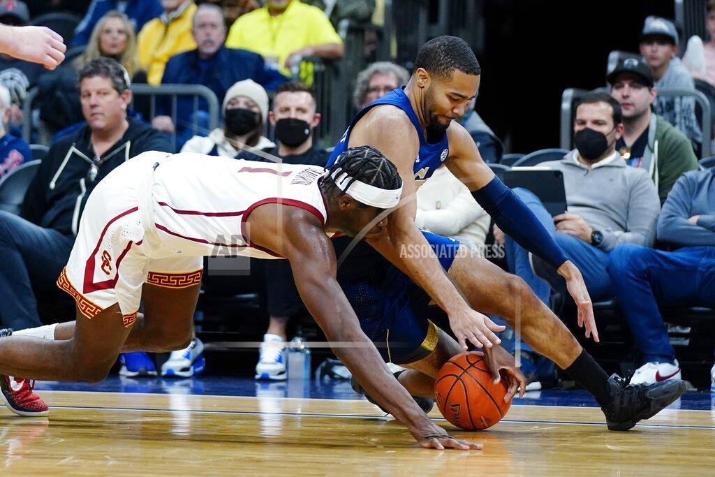 Ross D. Franklin Southern California forward Chevez Goodwin (1) and Georgia Tech guard Kyle Sturdivant, right, battle for a loose ball during the first half of an NCAA college basketball game at the Jerry Colangelo Classic Saturday, Dec. 18, 2021, in Phoenix. (AP Photo/Ross D. Franklin)