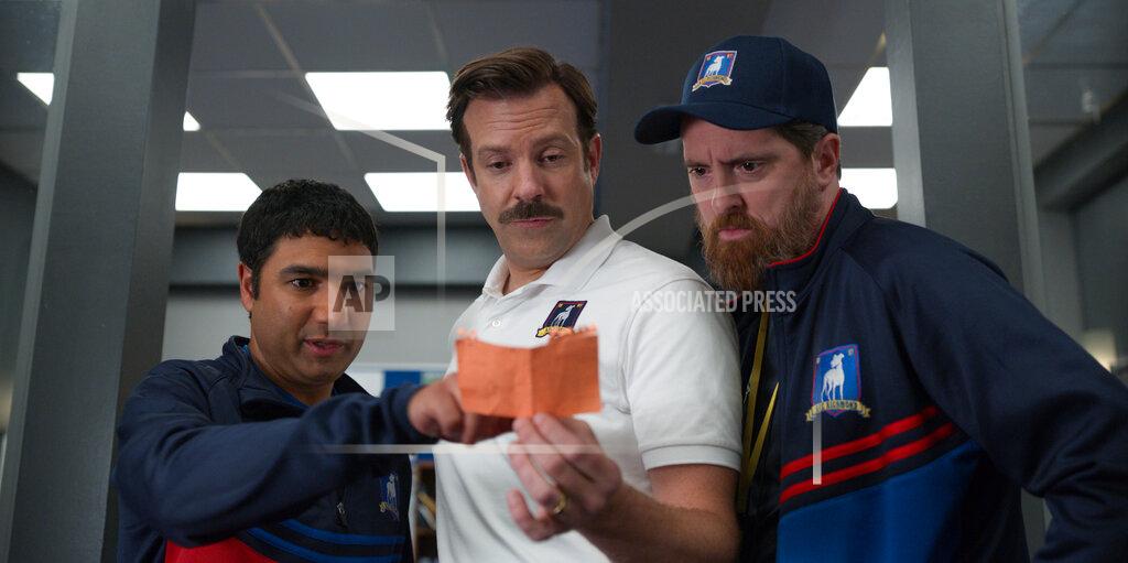 Uncredited This image released by Apple TV Plus shows Nick Mohammed, from left, Jason Sudeikis, and Brendan Hunt in "Ted Lasso." The Screen Actors Guild has nominated the cast for a SAG Award for best ensemble in a comedy series. (Apple TV Plus via AP)