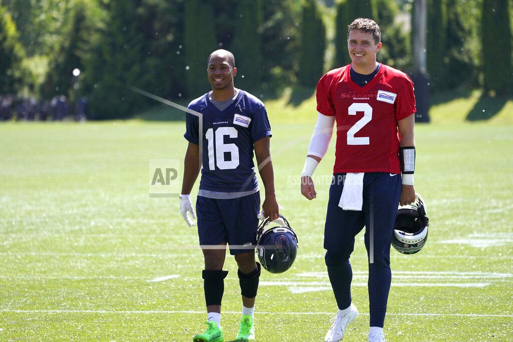 Ted S. Warren Seattle Seahawks quarterback Drew Lock (2) walks with wide receiver Tyler Lockett (16) after NFL football practice Tuesday, May 31, 2022, in Renton, Wash. (AP Photo/Ted S. Warren)