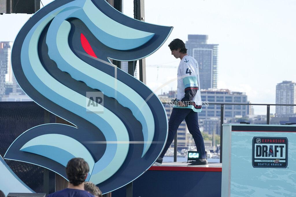 Ted S. Warren Hadyn Fluery, a defenseman from the Anaheim Ducks, walks off stage after being introduced as a new player with the Seattle Kraken NHL hockey team, Wednesday, July 21, 2021, during the Kraken's expansion draft event in Seattle. (AP Photo/Ted S. Warren)