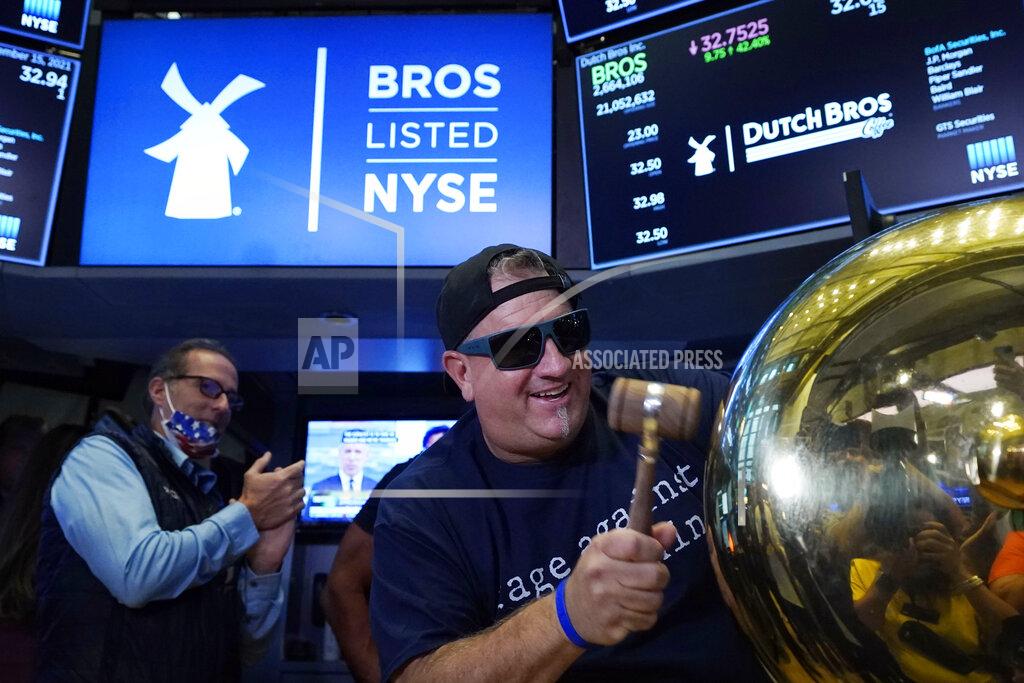 Richard Drew CORRECTS TITLE TO EXECUTIVE CHAIRMAN, NOT PRESIDENT - Dutch Bros Coffee Co-founder and Executive Chairman Travis Boersma rings the ceremonial first trade bell on the floor of the New York Stock Exchange, as his company's IPO opens, Wednesday, Sept. 15, 2021. (AP Photo/Richard Drew)
