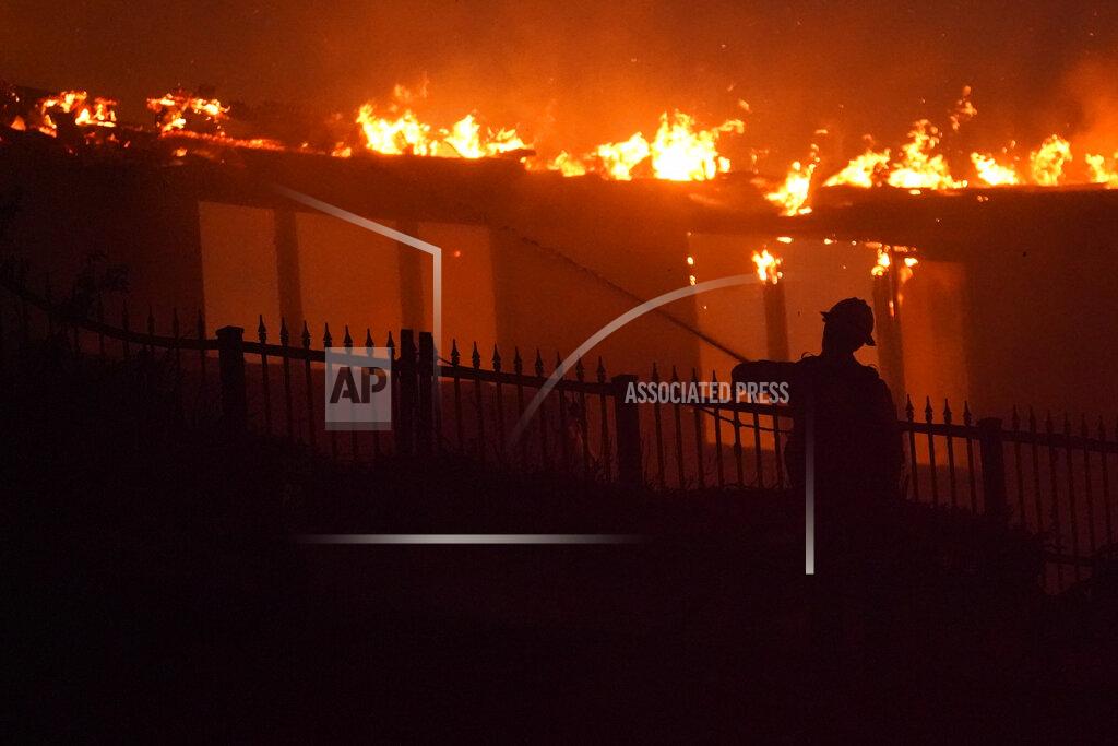 Marcio J. Sanchez A firefighter works to put out a structure burning during a wildfire Wednesday, May 11, 2022, in Laguna Niguel, Calif. (AP Photo/Marcio J. Sanchez)