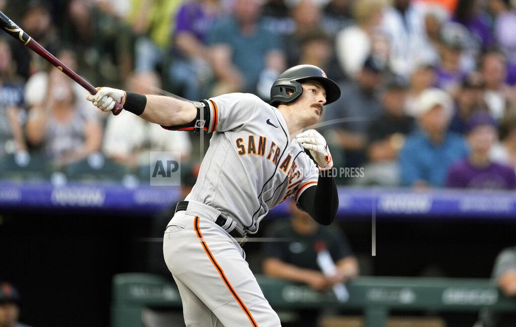 David Zalubowski San Francisco Giants' Mike Yastrzemski follows the flight of his double to drive in two runs off Colorado Rockies starting pitcher Chad Kuhl in the third inning of a baseball game Tuesday, May 17, 2022, in Denver. (AP Photo/David Zalubowski)