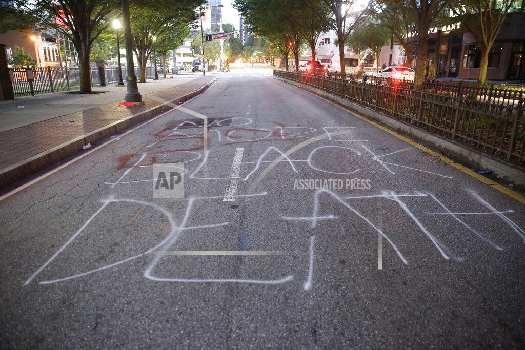 Brynn Anderson Spray painted on a road in downtown Atlanta reads "No More Black Death" in the aftermath of a demonstration against police violence on Saturday, May 30, 2020, in Atlanta. (AP Photo/Brynn Anderson)