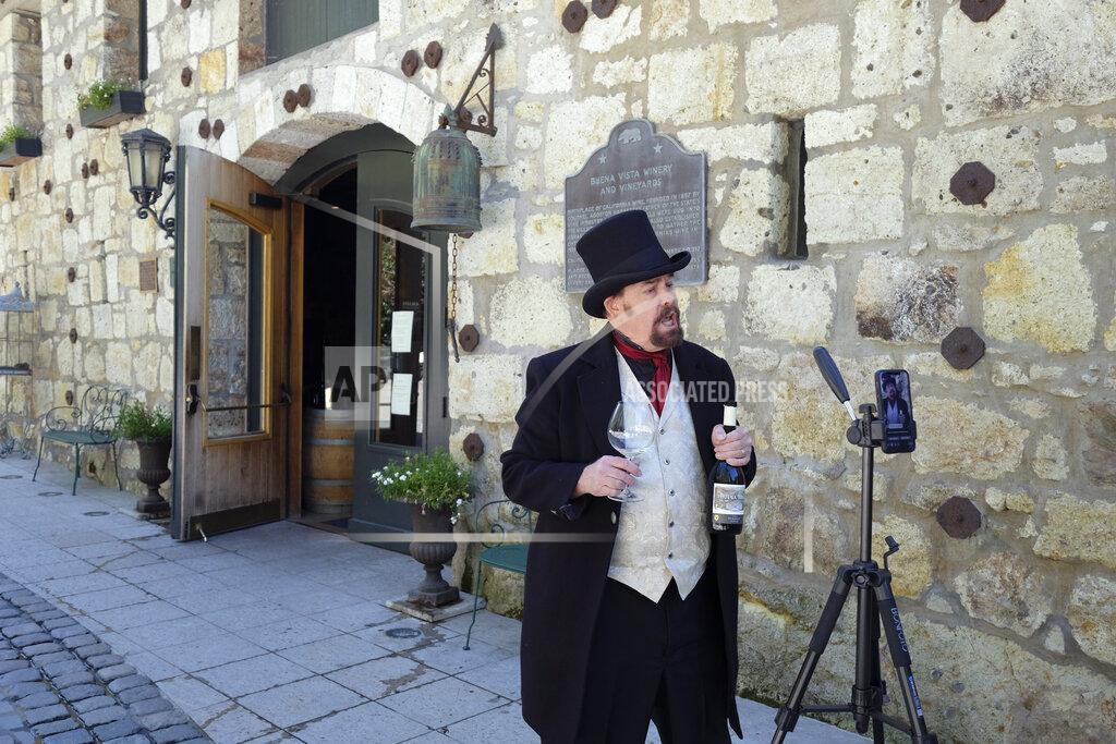 In this photo taken Wednesday, April 1, 2020, George Webber, dressed as "The Count" Agoston Haraszthy, leads a virtual online tasting and tour of the historic Buena Vista Winery in Sonoma, Calif. The winery is the state's oldest commercial winery dating to 1857. Wineries that want to stay viable and connected to their customers during the coronavirus pandemic are harnessing platforms such as Facebook Live to offer virtual wine experiences. . (AP Photo/Eric Risberg)