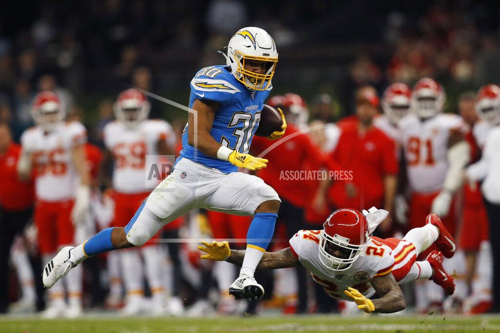 Eduardo Verdugo Los Angeles Chargers running back Austin Ekeler, left, gets past Kansas City Chiefs strong safety Jordan Lucas, right, during the first half of an NFL football game Monday, Nov. 18, 2019, in Mexico City. (AP Photo/Eduardo Verdugo)