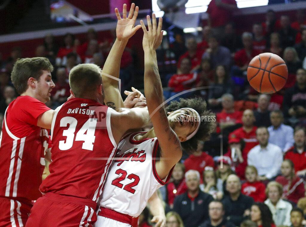 Andrew Mills Wisconsin guard Brad Davison (34) collides with Rutgers guard Caleb McConnell (22) as they battle under the basket during the first half of an NCAA college basketball game in Piscataway, N.J., Wednesday, Dec. 11, 2019. (Andrew Mills/NJ Advance Media via AP)
