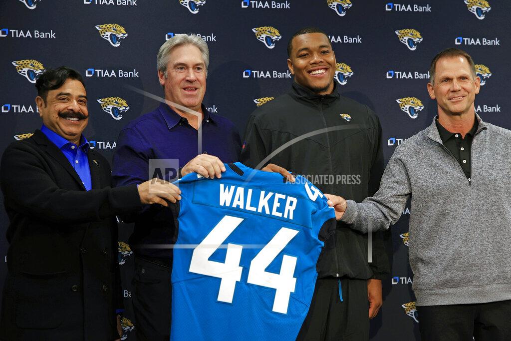 Corey Perrine Jacksonville Jaguars owner Shad Khan, from left, head coach Doug Pederson, first round draft pick Travon Walker, and Jacksonville Jaguars General Manager Trent Baalke hold a jersey during a press conference Friday, April 29, 2022 at TIAA Bank Field in Jacksonville, Fla. Travon Walker, a defensive lineman from the University of Georgia, was the overall No. 1 pick for the Jacksonville Jaguars in the 2022 NFL Draft. (Corey Perrine/The Florida Times-Union via AP)