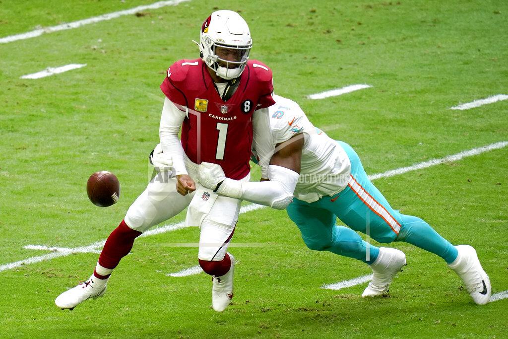 Ross D. Franklin FILE - Miami Dolphins defensive end Emmanuel Ogbah (91) forces Arizona Cardinals quarterback Kyler Murray (1) to fumble during the first half of an NFL football game in Glendale, Ariz., in this Sunday, Nov. 8, 2020, file photo. The Dolphins recovered for a touchdown. A breakout season has the Dolphins keen to keep him around. Ogbah is tied for fourth in the NFL with a career-high eight sacks, and has had at least one sack in each of the past six games.(AP Photo/Ross D. Franklin, File)