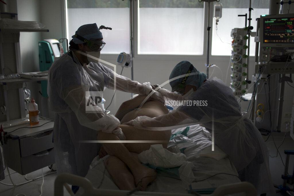 Daniel Cole Nurses tend to a patient suffering from COVID-19 in the ICU at the La Timone hospital in Marseille, southern France, Tuesday Feb. 2, 2021. COVID patients occupy 88% of the Marseille region's intensive care beds, and virus pressure on French hospitals is steadily rising in recent weeks despite curfews and other restrictions. (AP Photo/Daniel Cole)