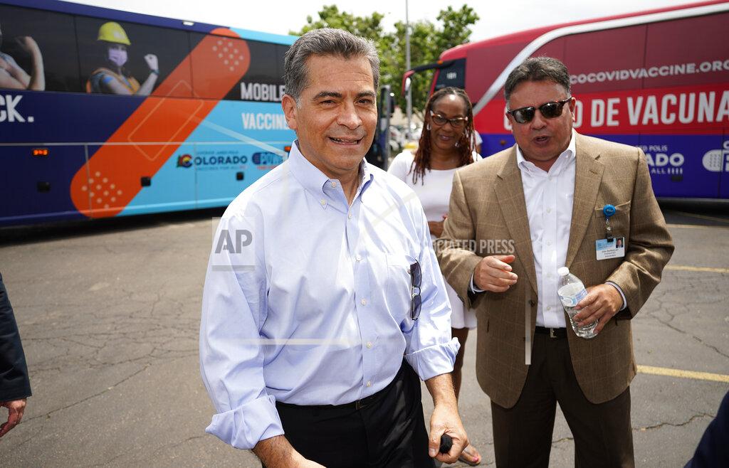 David Zalubowski U.S. Department of Health and Human Services Secretary Xavier Becerra heads to a podium to speak during a visit to a pair of buses set up as traveling clinics as part of the state's "Vaccines For All" campaign Friday, June 18, 2021, in Aurora, Colo. The buses are being used to distribute COVID-19 vaccines. (AP Photo/David Zalubowski)