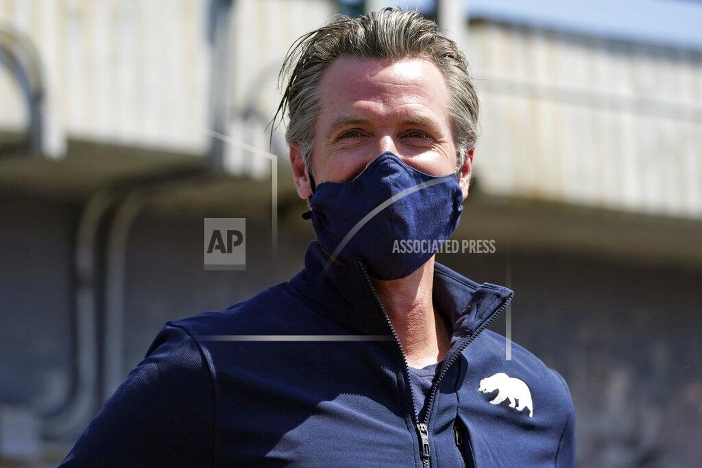 Marcio Jose Sanchez California Gov. Gavin Newsom smiles as he readies to hold a news conference Tuesday, May 11, 2021, in Los Angeles. Newsom on Tuesday proposed $12 billion in new funding to get more people experiencing homelessness in the state into housing and to "functionally end family homelessness" within five years. (AP Photo/Marcio Jose Sanchez)