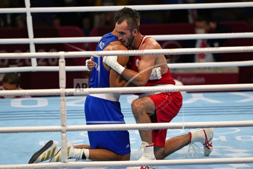 Themba Hadebe Russian Olympic Committee's Muslim Gadzhimagomedov, right, hugs New Zealand's David Nyika after winning their men's heavyweight 91kg semifinal boxing match at the 2020 Summer Olympics, Tuesday, Aug. 3, 2021, in Tokyo, Japan. (AP Photo/Themba Hadebe)