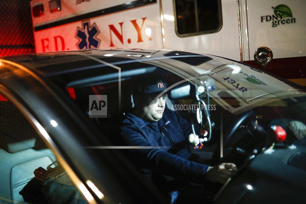John Minchillo FILE - In this April 6, 2020, file photo, paramedic Travis Kessel is photographed outside his station house after working a shift amid the COVID-19 pandemic, in the Bronx borough of New York. Kessel never imagined his work could hurt this much. He loves his career in emergency services. It's even how he met his wife, an emergency room nurse. But now he worries about the toll the new coronavirus is taking on both of them and their colleagues. (AP Photo/John Minchillo, File)