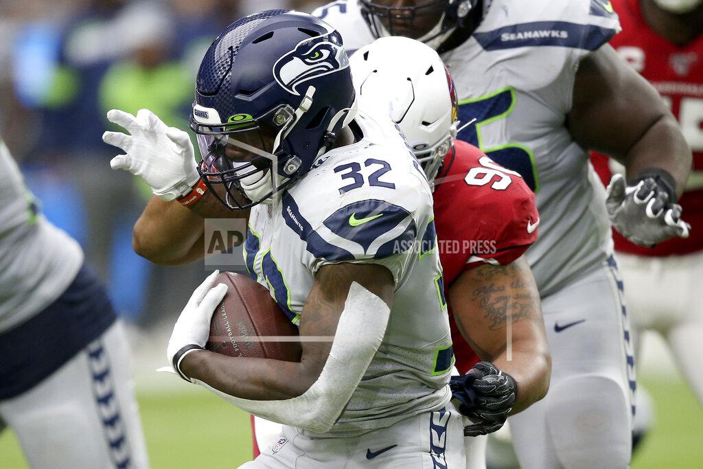 Ross D. Franklin Seattle Seahawks running back Chris Carson (32) runs as Arizona Cardinals defensive end Jonathan Bullard defends during the first half of an NFL football game, Sunday, Sept. 29, 2019, in Glendale, Ariz. (AP Photo/Ross D. Franklin)
