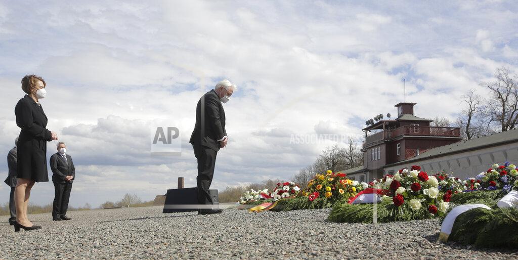 Markus Schreiber German President Frank-Walter Steinmeier, center, lays down a wreath during commemorations marking the 76th anniversary of the liberation of the Nazi concentration camp Buchenwald near Weimar, Germany, Sunday, April 11, 2021. On April 11, 1945 the US Army liberated the concentration camp Buchenwald. At left is Steinmeier's wife Elke Buendenbender. (AP Photo/Markus Schreiber)