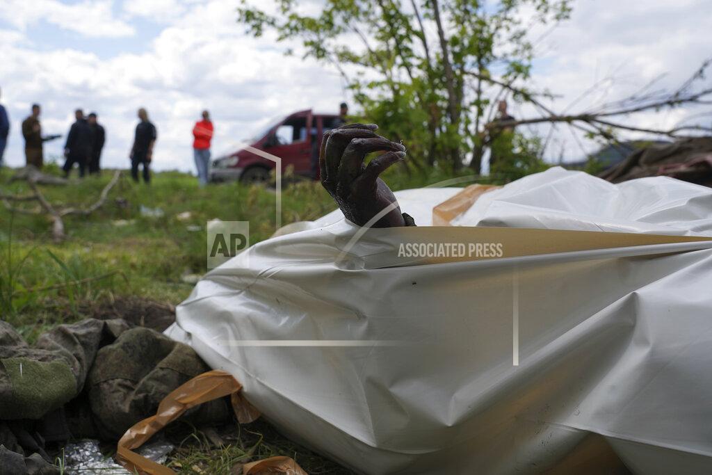 Andrii Marienko The withered hand of a dead Russian soldier pokes out of a body bag during the exhumation of killed Russian soldiers' at their former positions near the village of Malaya Rohan, on the outskirts of Kharkiv, Wednesday May 18, 2022. (AP Photo/Andrii Marienko)