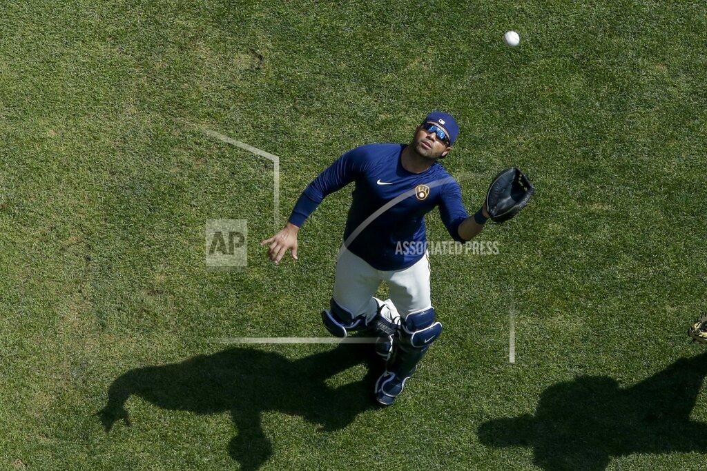 Morry Gash Milwaukee Brewers' Manny Pina catches a ball during a practice session Monday, July 13, 2020, at Miller Park in Milwaukee. (AP Photo/Morry Gash)