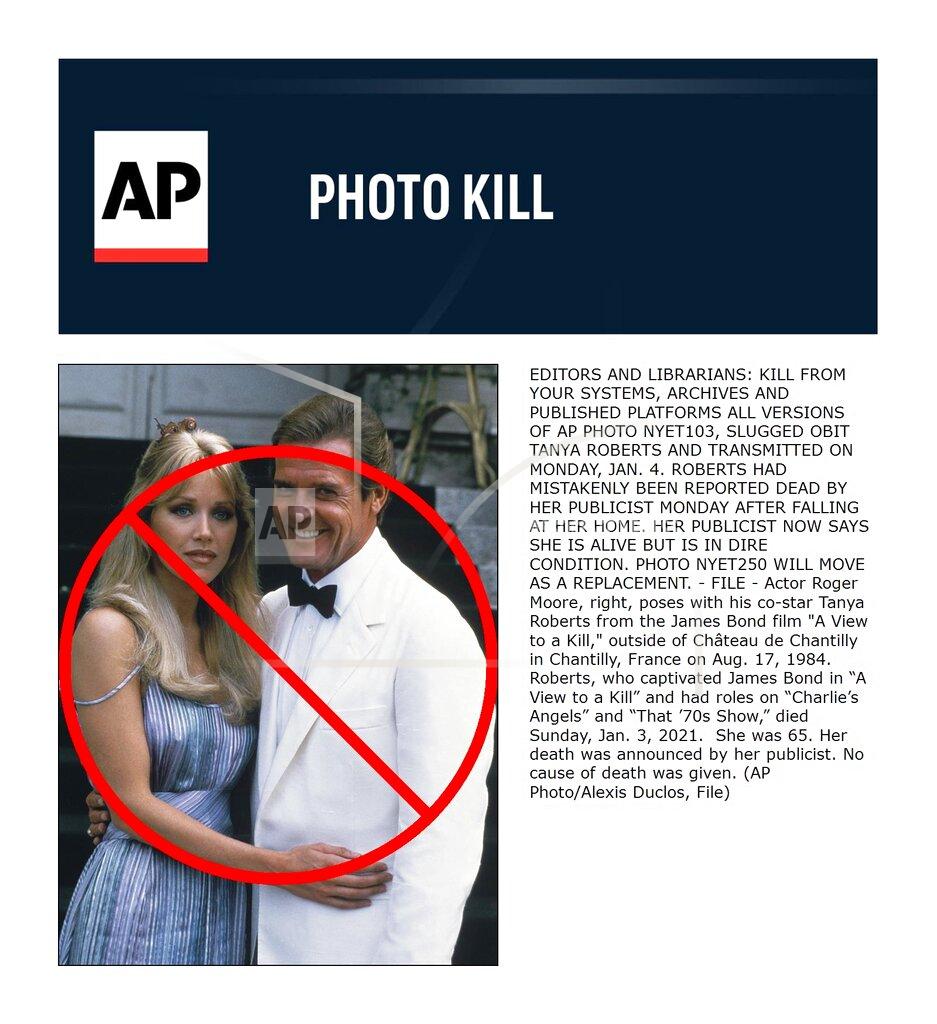 Alexis D. FILE - Actor Roger Moore, right, poses with his co-star Tanya Roberts from the James Bond film "A View to a Kill," outside of Château de Chantilly in Chantilly, France on Aug. 17, 1984. Roberts, who captivated James Bond in “A View to a Kill” and had roles on “Charlie’s Angels” and “That ’70s Show,” died Sunday, Jan. 3, 2021. She was 65. Her death was announced by her publicist. No cause of death was given. (AP Photo/Alexis Duclos, File)