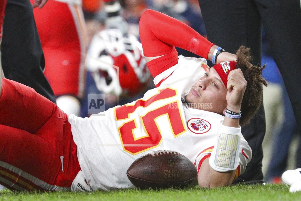 Kansas City Chiefs quarterback Patrick Mahomes (15) looks lies on the ground after dislocating his knee in an NFL game against the Denver Broncos, Thursday, Oct. 17, 2019, in Denver. The Chiefs defeated the Broncos 30-6. (Margaret Bowles via AP)