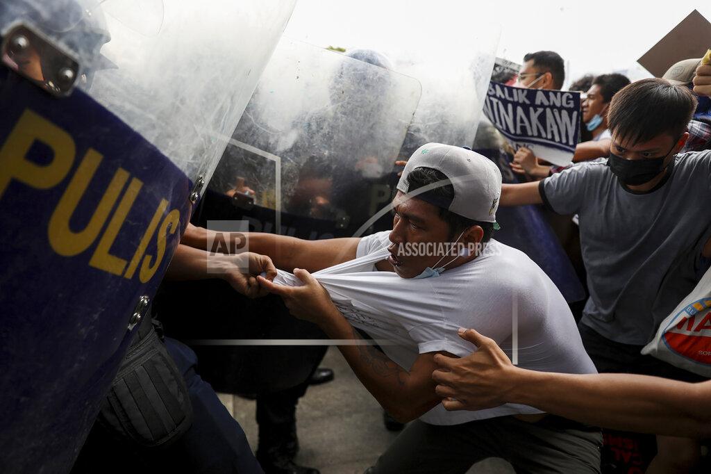 Basilio Sepe Police disperse activists protesting against the upcoming proclamation of presidential frontrunner Ferdinand "Bongbong" Marcos Jr. and running mate Sara Duterte, daughter of the current president, during a rally at the Commission on Human Rights in Quezon City, Metro Manila, Philippines on Wednesday May 25, 2022. Marcos Jr. continues to lead in the official canvassing of votes. (AP Photo/Basilio Sepe)