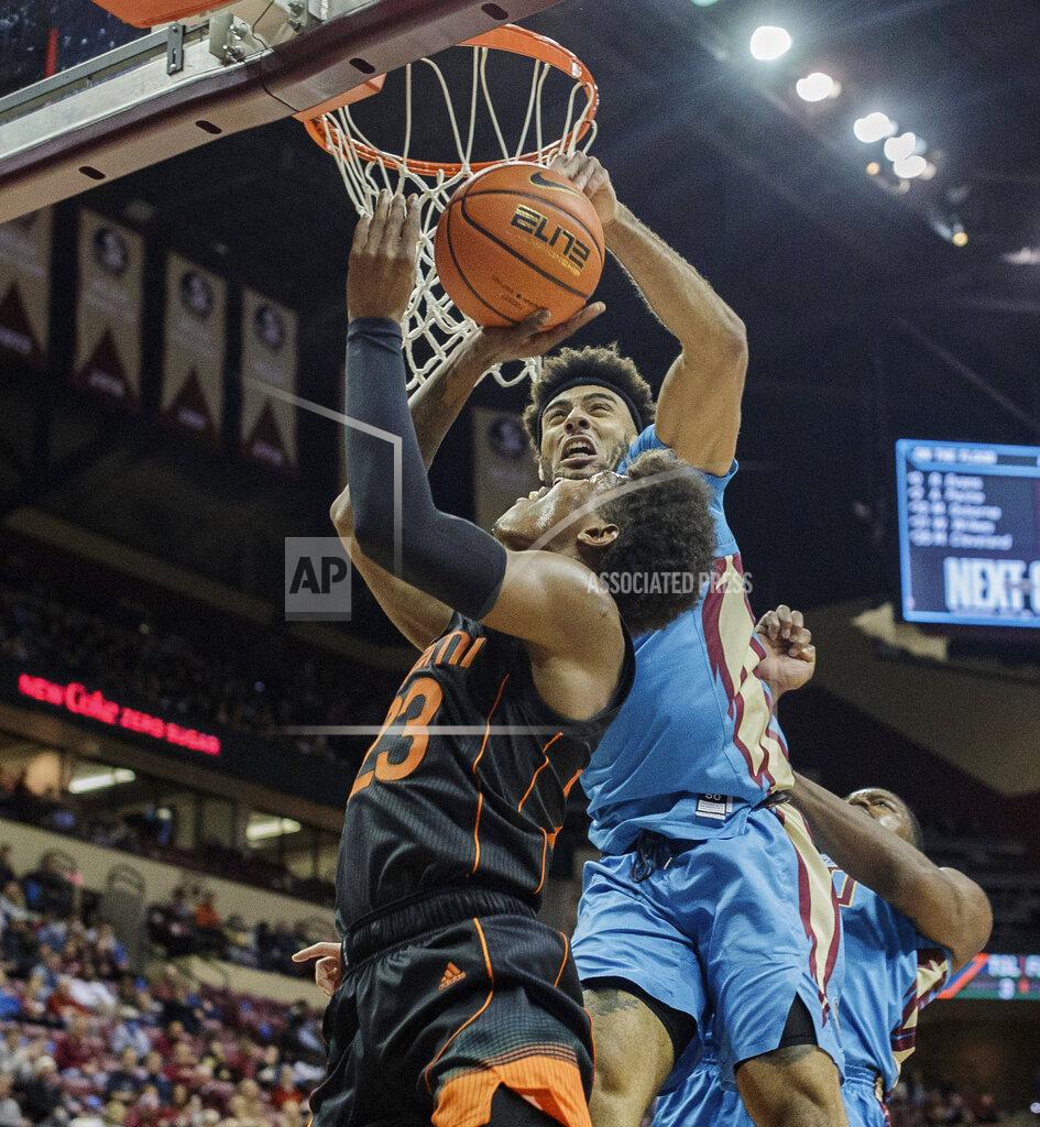 Alicia Devine Miami guard Kameron McGusty (23) is blocked by Florida State guard Anthony Polite (2) during an NCAA college basketball game at the Tucker Civic Center on Tuesday, Jan. 11, 2022, Tallahassee, Fla. (Alicia Devine/Tallahassee Democrat via AP)