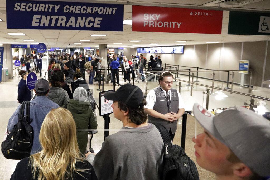 FILE - In this Wednesday, Nov. 27, 2019, file photo, travelers walk through a security checkpoint in Terminal 2 at Salt Lake City International Airport, in Salt Lake City. Federal officials are considering requiring that all travelers, including American citizens, be photographed as they enter or leave the country as part of an identification system using facial-recognition technology. (AP Photo/Rick Bowmer, File)