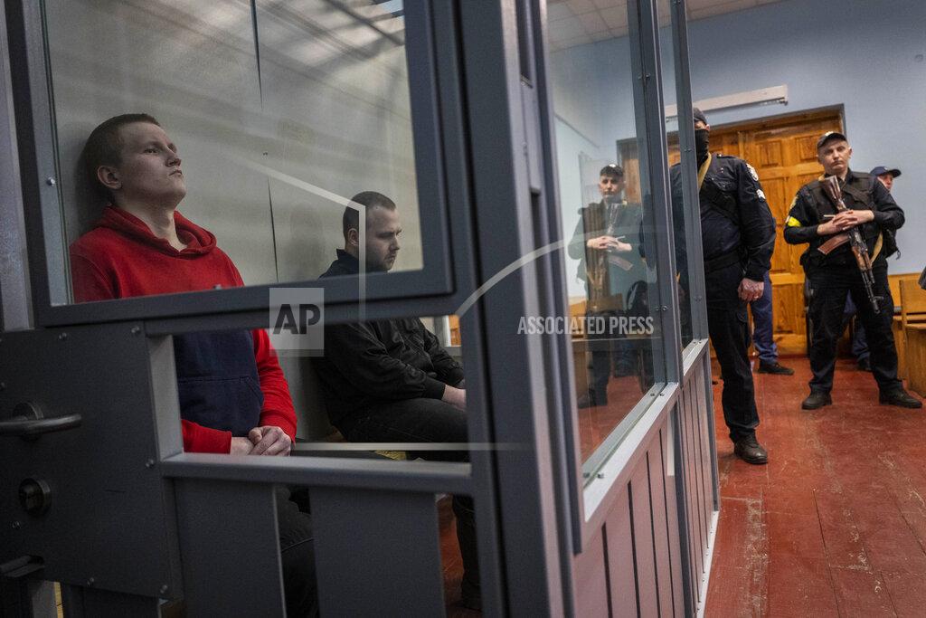 Bernat Armangue Russian soldiers Alexander Alexeevich Ivanov and Alexander Vladimirovich Bobykin, left, attend their trial hearing in Kotelva, northeastern Ukraine, Thursday, May 26, 2022. Two Russian soldiers accused of war crime in Ukraine could face up to 12 years in prison. In the second hearing of the trial held on Thursday at the Kotelevsky District Court, the prosecutors asked for both to be sentenced to 12 years of prison, while the defence attorney asked for 8 years. (AP Photo/Bernat Armangue)