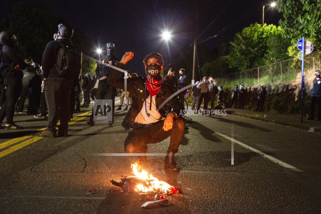 Sean Meagher Protesters gather outside the East Side Police Station in Portland, Ore., Thursday, July 16, 2020. Federal officers deployed tear gas and fired less-lethal rounds into a crowd of protesters late Thursday. The actions came just hours after the head of the Department of Homeland Security called the protesters “violent anarchists.” (Sean Meagher/The Oregonian via AP)
