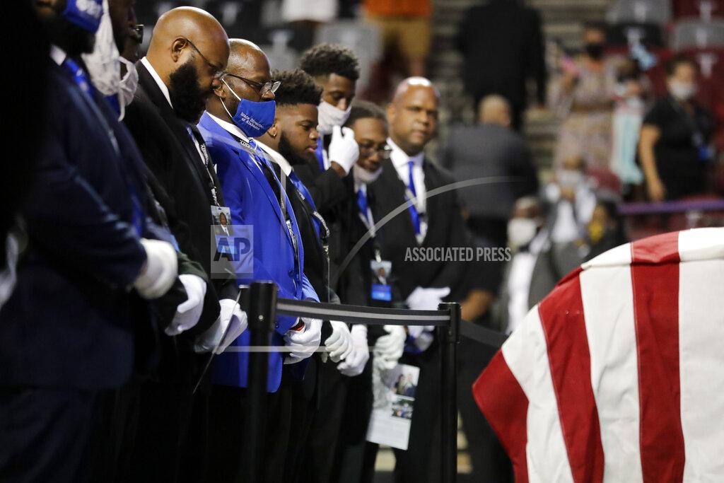 Brynn Anderson Fraternity members sing in front of the casket of the late Rep. John Lewis, D-Ga., during a service celebrating "The Boy from Troy" at Troy University on Saturday, July 25, 2020, in Troy, Ala. Lewis, who carried the struggle against racial discrimination from Southern battlegrounds of the 1960s to the halls of Congress, died Friday, July 17, 2020. (AP Photo/Brynn Anderson)