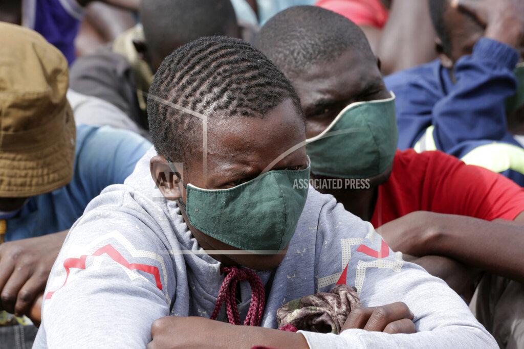 Tsvangirayi Mukwazhi Prisoners are briefed about the dangers of the coronavirus following their release from Chikurubi prison on the outskirts of Harare, Saturday, April 17, 2021. Zimbabwe began the release of about 3,000 prisoners under a presidential amnesty aimed at easing congestion and minimizing the threat of COVID-19 across the country's overcrowded jails. (AP Photo/Tsvangirayi Mukwazhi)