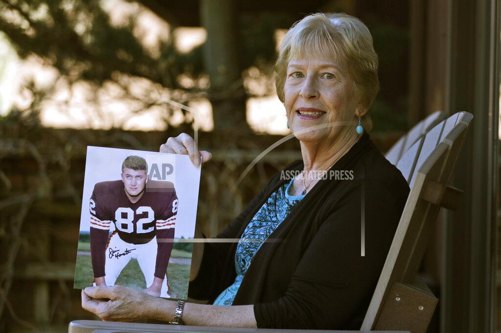 Tony Dejak Donna Houston holds up a photograph of her husband, Jim, during his playing years with the Cleveland Browns, Friday, April 3, 2020, in Sagamore Hills, Ohio. Houston's widow would keep notes on her husband's deteriorating condition in a three-ring binder so she would be prepared for the day when he needed full-time care. (AP Photo/Tony Dejak)
