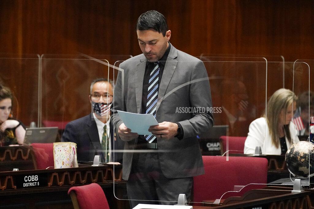 Matt York Republican Rep. Leo Biasiucci reads over legislation at the Capitol, Thursday, Feb. 18, 2021, in Phoenix. In Arizona, a Senate proposal that passed the chamber on Wednesday, March 3, 2021, would allow police officers to be sued for enforcing federal gun restrictions that the state considers violations of the Second Amendment. They potentially could face criminal charges. A bill in the House doesn't include those punishments, but its sponsor, Biasiucci, said it would be a clear rejection of federal restrictions on assault-style weapons, high-capacity magazines or other firearms. (AP Photo/Matt York)