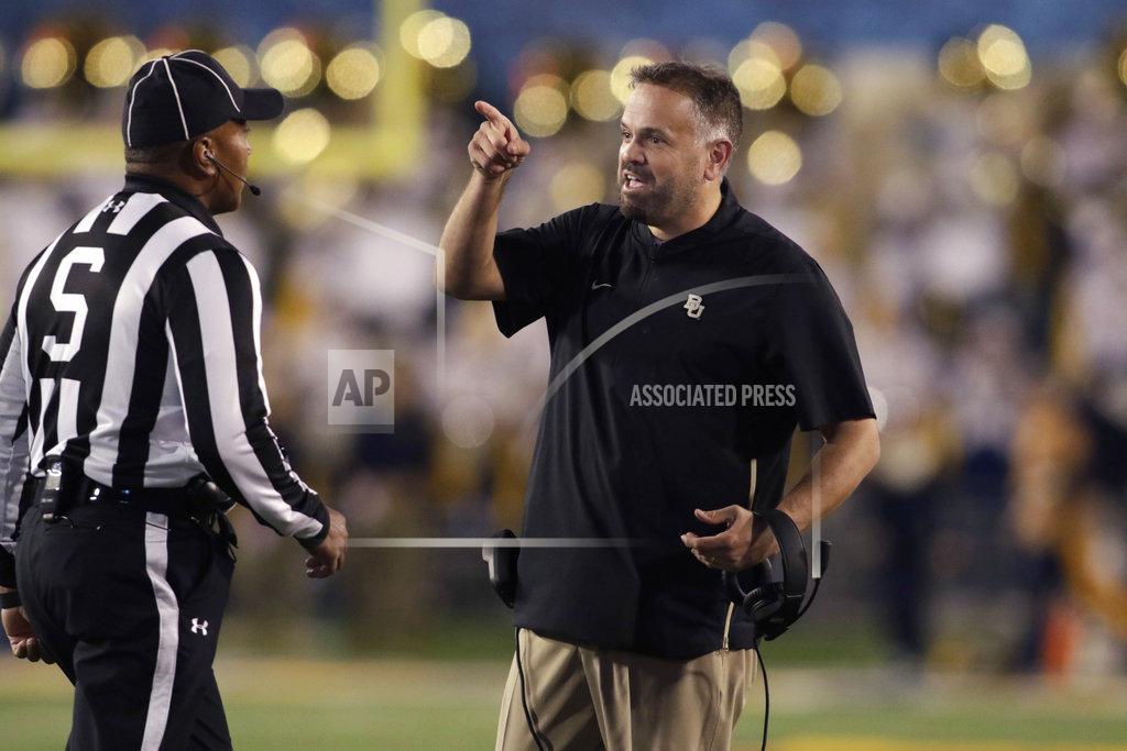 Ray Thompson Baylor head coach Matt Rhule, right, complains to the referees during the second half of an NCAA college football game against West Virginia, Thursday, Oct. 25, 2018, in Morgantown, W.Va. (AP Photo/Raymond Thompson)