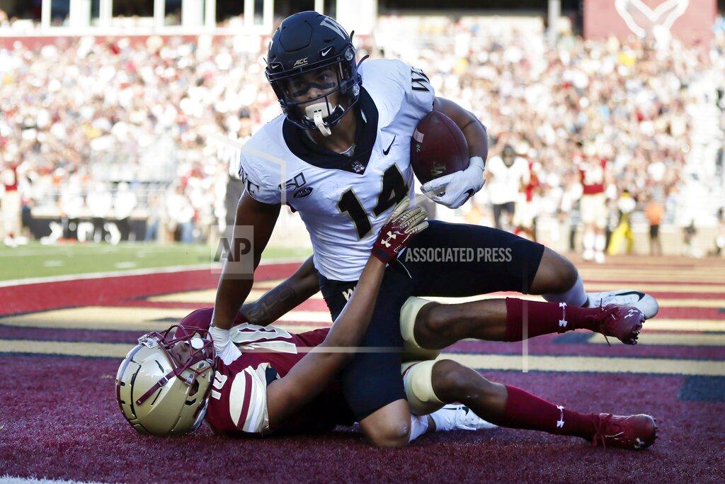 Michael Dwyer Wake Forest wide receiver Sage Surratt (14) comes down with a touchdown pass against Boston College defensive back Brandon Sebastian during the first half of an NCAA college football game in Boston, Saturday, Sept. 28, 2019. (AP Photo/Michael Dwyer)