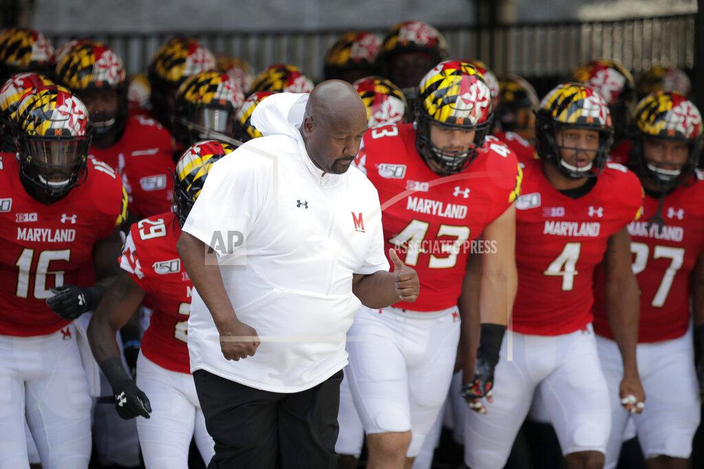 Julio Cortez Maryland head coach Michael Locksley, center, leads his team onto the field for an NCAA college football game against Howard, Saturday, Aug. 31, 2019, in College Park, Md. (AP Photo/Julio Cortez)
