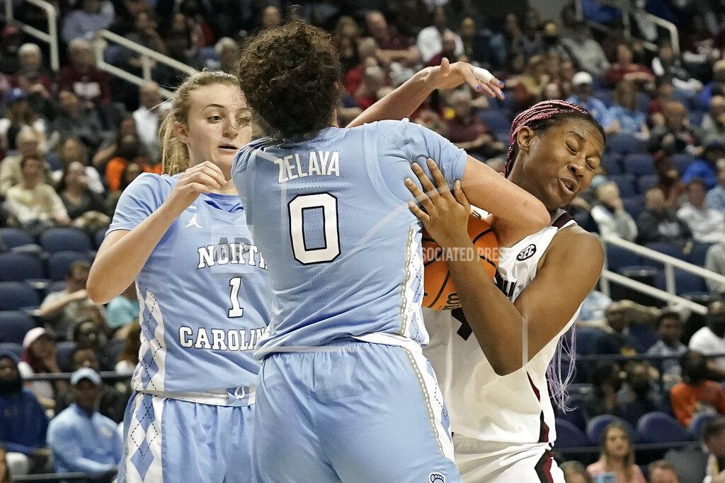Gerry Broome South Carolina forward Aliyah Boston, right, struggles for a rebound with North Carolina guard Alyssa Ustby (1) and forward Alexandra Zelaya (0) during the second half of a college basketball game in the Sweet 16 round of the NCAA tournament in Greensboro, N.C., Friday, March 25, 2022. (AP Photo/Gerry Broome)