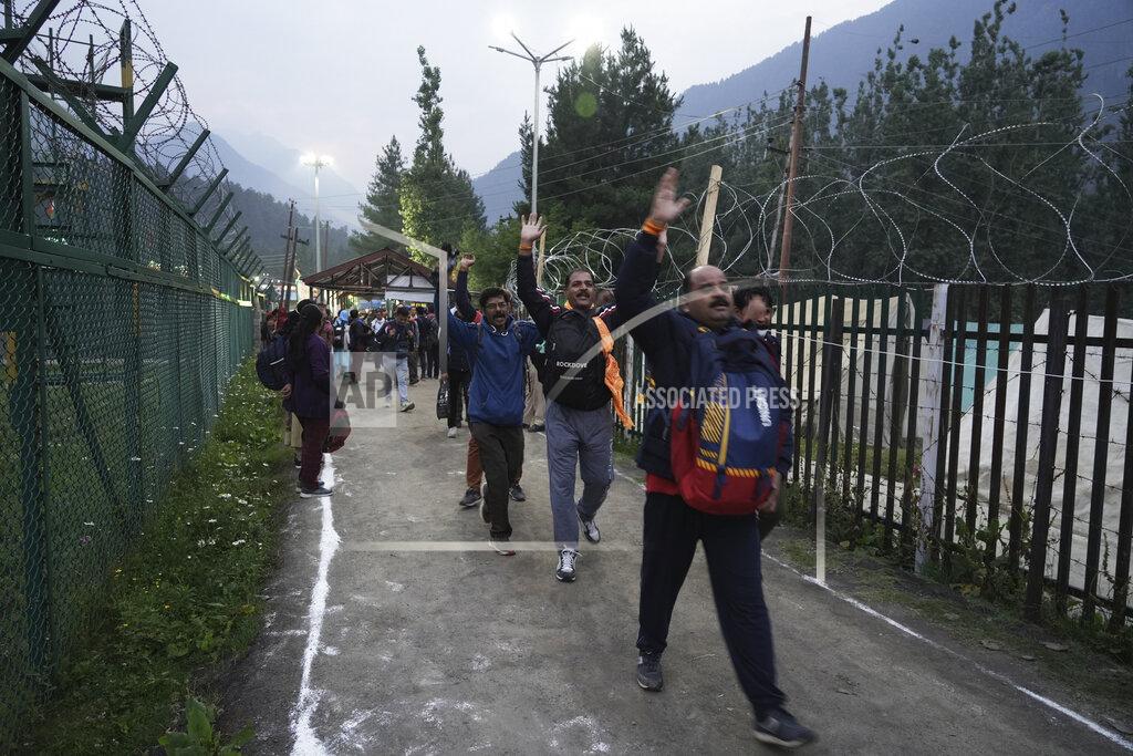 Uncredited Hindu devotees leave for the Amarnath Yatra annual pilgrimage to an icy Himalayan cave, in Nunwun, Pahalgam, south of Srinagar, Indian-controlled Kashmir, Thursday, June 30, 2022. Officials say pilgrims face heightened threat of attacks from rebels fighting against Indian rule and have for the first time tagged devotees with wireless tracking system. They also have deployed drones for surveillance. (AP Photo)