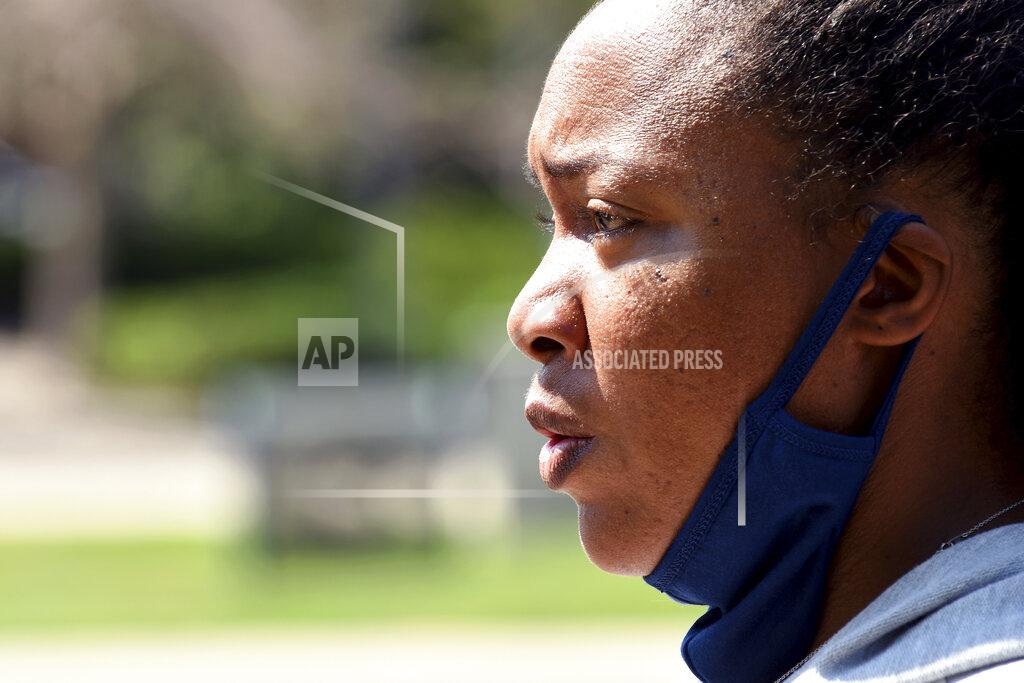 Thomas Peipert Community activist Lindsay Minter speaks during a news conference in Aurora, Colo., on Wednesday, July 28, 2021. Local activists and former members of Aurora's community police task force gathered to call attention to police brutality. Aurora police announced Monday that an officer was arrested after video showed him using his pistol to beat a man he was trying to take into custody, choking him and threatening to kill him, while another officer was accused of failing to stop her colleague. (AP Photo/Thomas Peipert)
