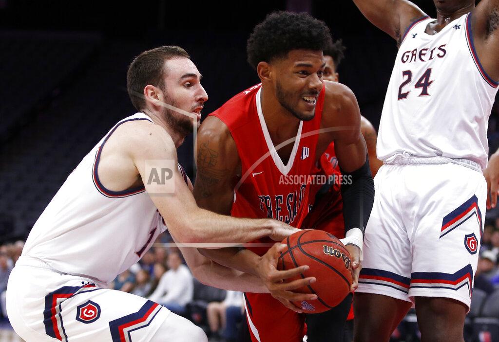 Rich Pedroncelli St. Mary's Tommy Kuhse, left, tries to get the ball from Fresno State forward Chris Seeley during the second half of an NCAA college basketball game in Sacramento, Calif., Wednesday, Nov. 20, 2019. Saint Mary's won 68-58. (AP Photo/Rich Pedroncelli)