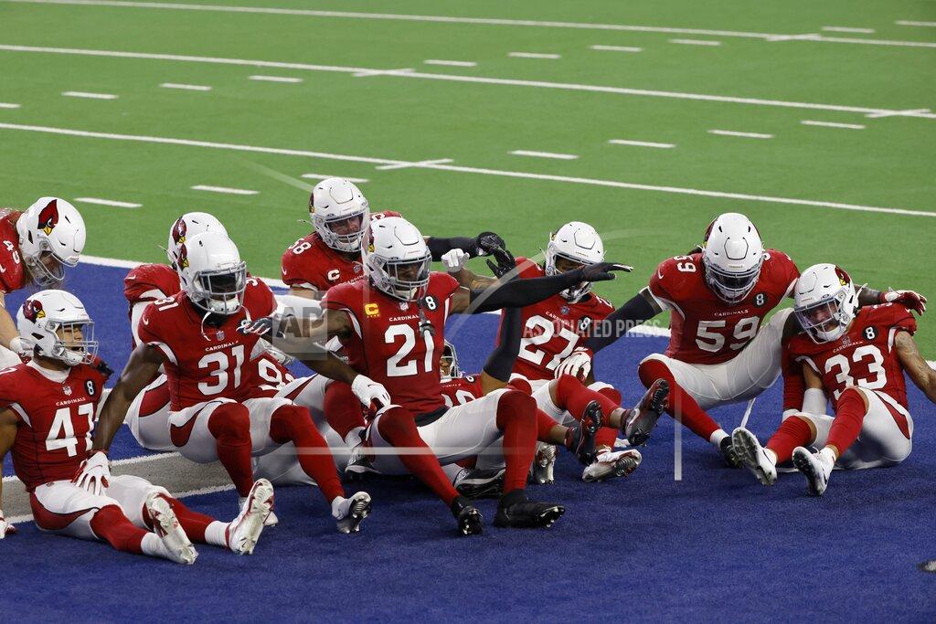 Ron Jenkins Members of the Arizona Cardinals defense act out a bowling pin strike dramatization after being hit by a ball rolled by Byron Murphy Jr. who intercepted a Dallas Cowboys quarterback Andy Dalton pass in the second half of an NFL football game in Arlington, Texas, Monday, Oct. 19, 2020. (AP Photo/Ron Jenkins)