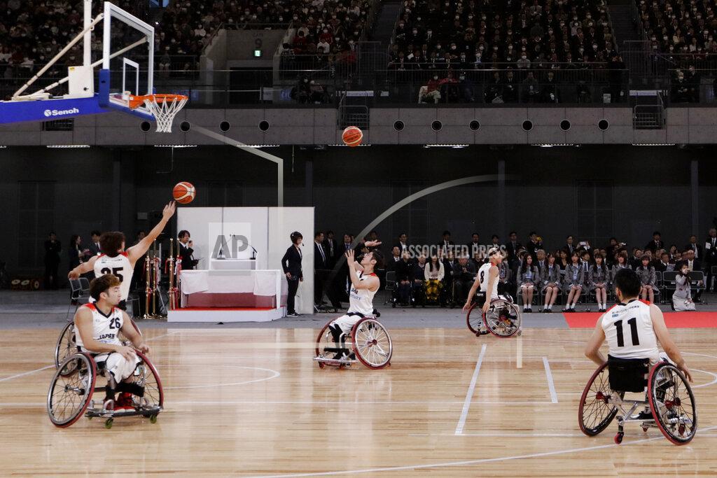 FILE - In this Feb. 2, 2020, file photo, members of Japan's national wheelchair basketball team warm up on the court during a grand opening ceremony of the Ariake Arena, a venue for volleyball at the Tokyo 2020 Olympics and wheelchair basketball during the Paralympic Games, in Tokyo. The opening next week of the Paralympic Games in Tokyo is being used as a stage to launch a human rights movement aimed at the world’s 1.2 billion people with disabilities.(AP Photo/Jae C. Hong, File)