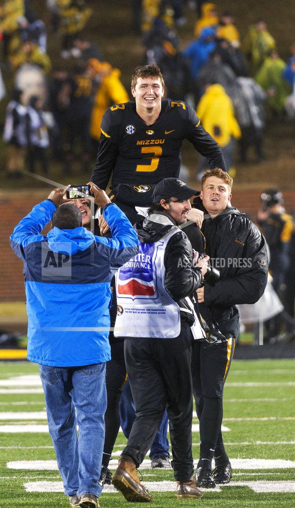 L.g. Patterson Missouri quarterback Drew Lock, top, is carried off by teammates after Missouri defeated Arkansas 38-0 in an NCAA college football game Friday, Nov. 23, 2018, in Columbia, Mo. . (AP Photo/L.G. Patterson)