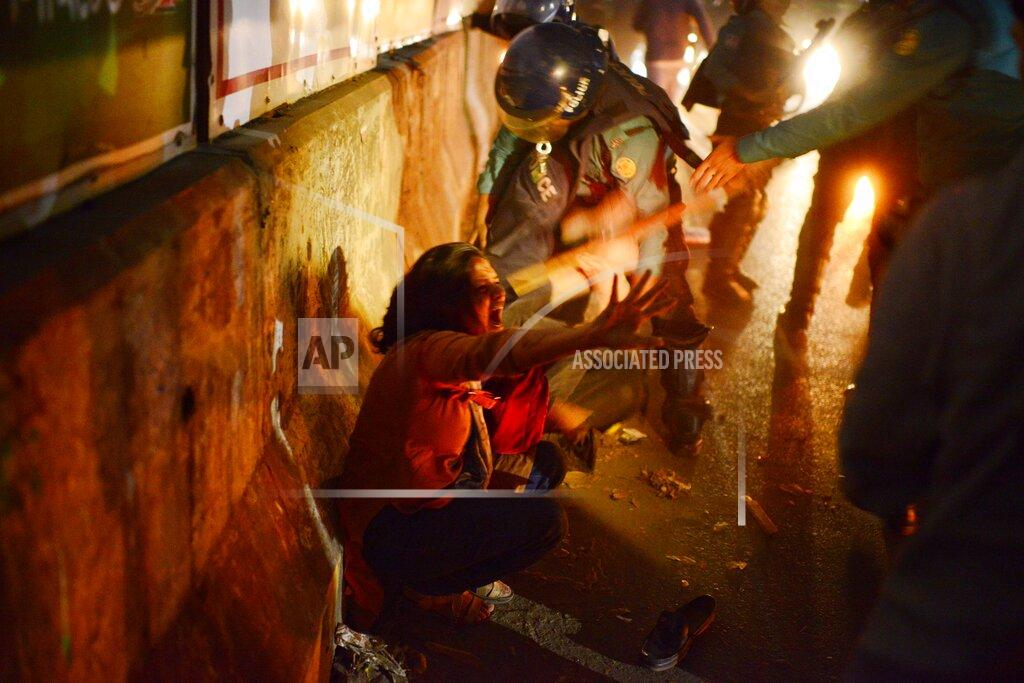 Mahmud Hossain Opu Policemen beat a demonstrator participating in a protest against the death in prison of a writer who was arrested on charges of violating the sweeping digital security, in Dhaka, Bangladesh, Friday, Feb. 26, 2021. Mushtaq Ahmed, 53, was arrested in Dhaka in May last year for making comments on social media that criticized the Prime Minister Sheikh Hasina government's handling of the coronavirus pandemic. He had been denied bail at least six times. (AP Photo/Mahmud Hossain Opu)