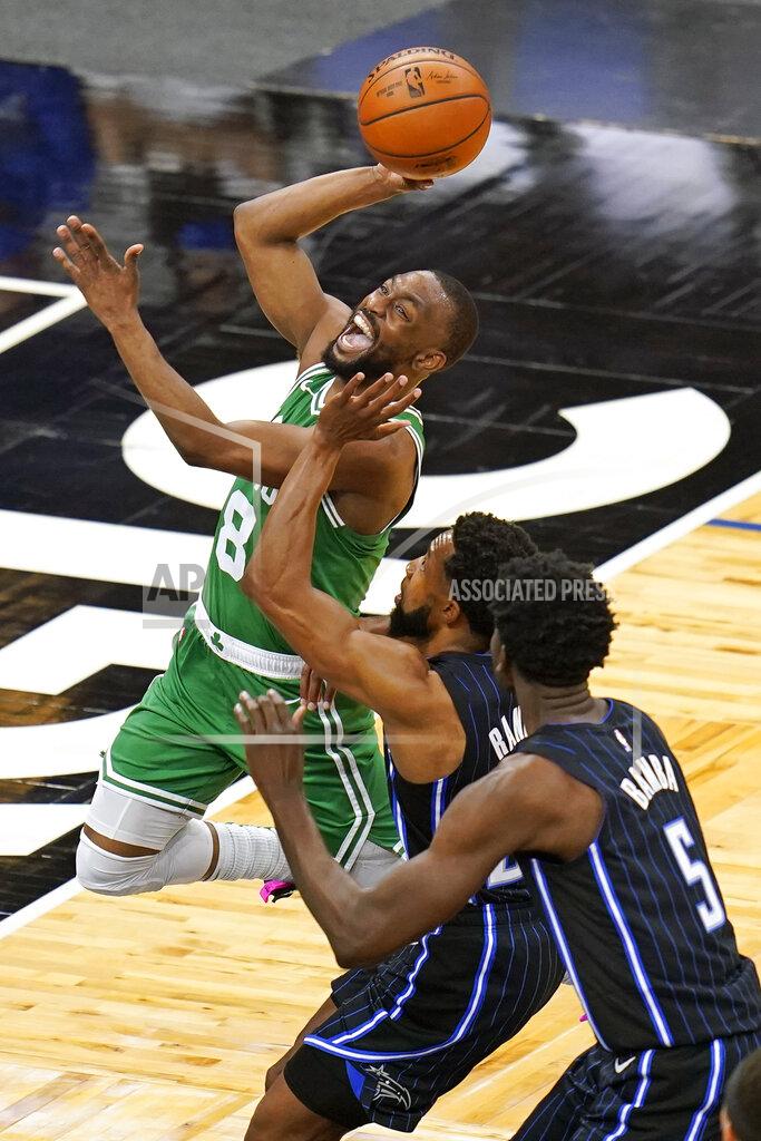 John Raoux Boston Celtics guard Kemba Walker (8) goes to the basket for a shot past Orlando Magic guard Chasson Randle, center, and center Mo Bamba (5) during the first half of an NBA basketball game, Wednesday, May 5, 2021, in Orlando, Fla. (AP Photo/John Raoux)