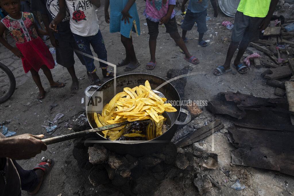 Rodrigo Abd A vendor fries a batch of plantains at a market in the La Saline neighborhood near the main port entrance, partially burned by a gang two years ago, in Port-au-Prince, Haiti, Monday, Sept. 13, 2021. There could be as many as 100 gangs in Port-au-Prince; no one has an exact count and allegiances often are violently fluid. (AP Photo/Rodrigo Abd)