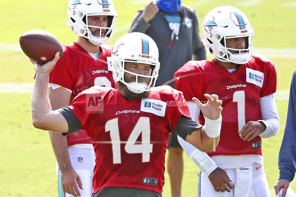 Charles Trainor Jr FILE - Miami Dolphins quarterback' Ryan Fitzpatrick passes as quarterbacks Tua Tagovailoa (1) and Josh Rosen (3) look on at their NFL football training facility in Davie, Fla., Monday, Aug. 17, 2020. At least four Dolphins rookies are expected to see significant action in Sunday’s, Sept. 13 opener, and none of them is named Tua Tagovailoa. (Charles Trainor Jr./Miami Herald via AP, File)