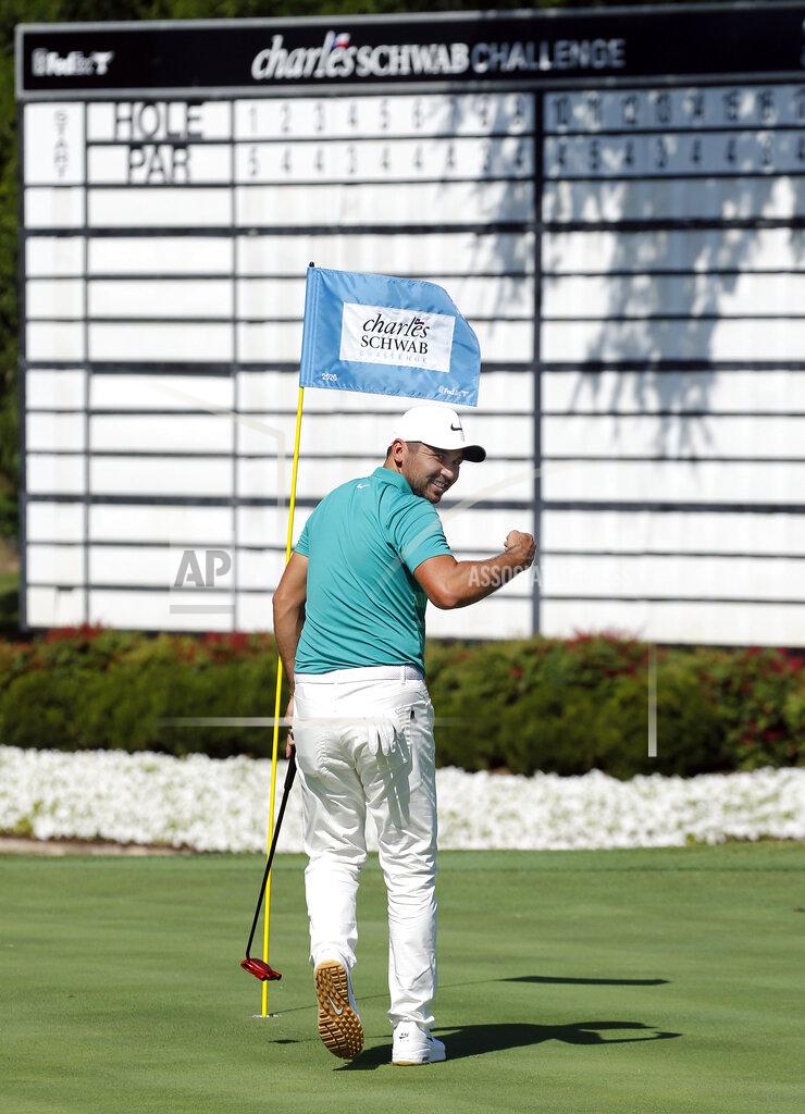 Tom Fox Jason Day turns to his caddie and pumps his fist after sinking a putt on No. 18 during practice for the Charles Schwab Challenge golf tournament at the Colonial Country Club in Fort Worth, Texas, Tuesday, June 9, 2020. The Challenge is the first PGA tour event since the COVID-19 pandemic began. (Tom Fox/The Dallas Morning News via AP)